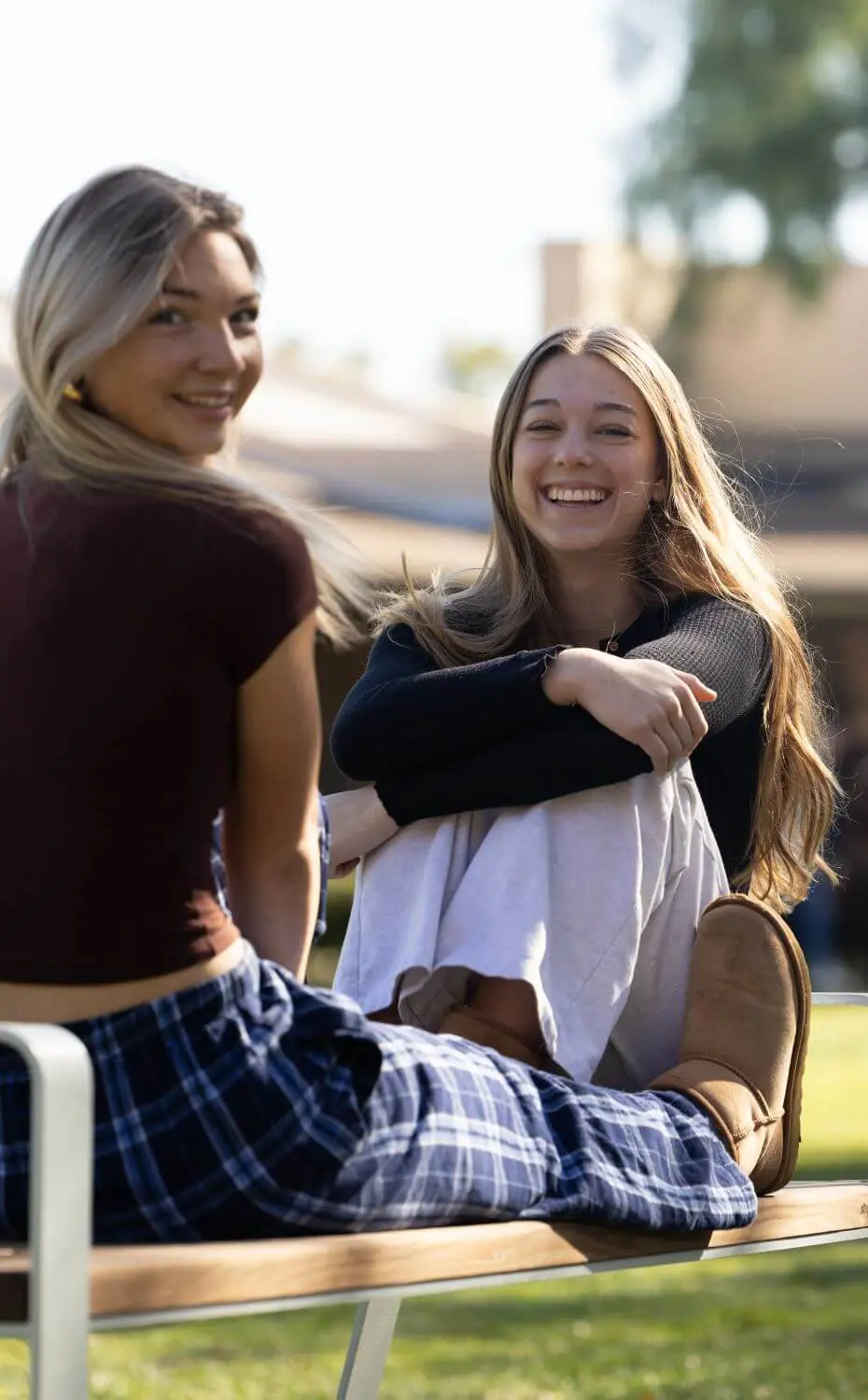 Two Chadwick students sitting on a bench on Vanderlip Lawn.