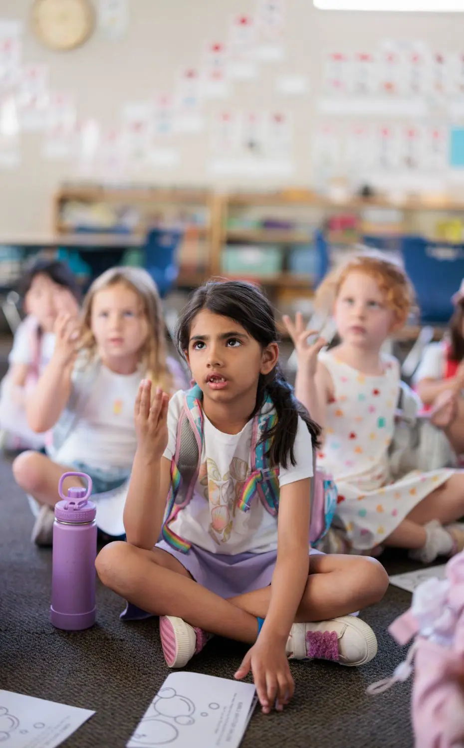 Chadwick Village students practice math while sitting on the carpet during class.