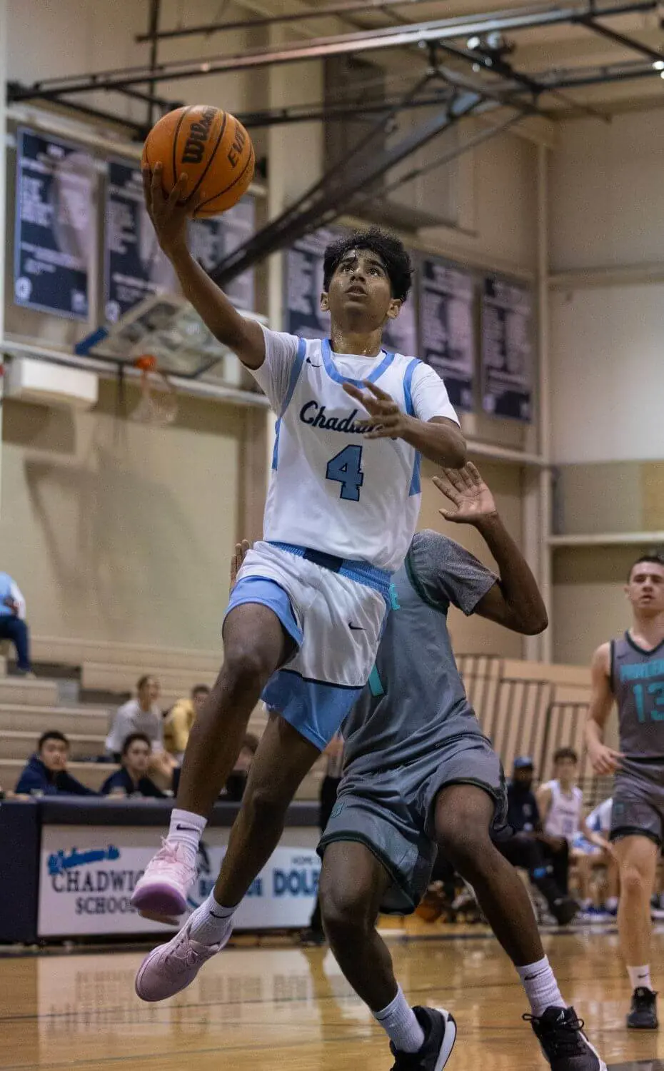 Chadwick boys basketball team member jumping to score in a game.