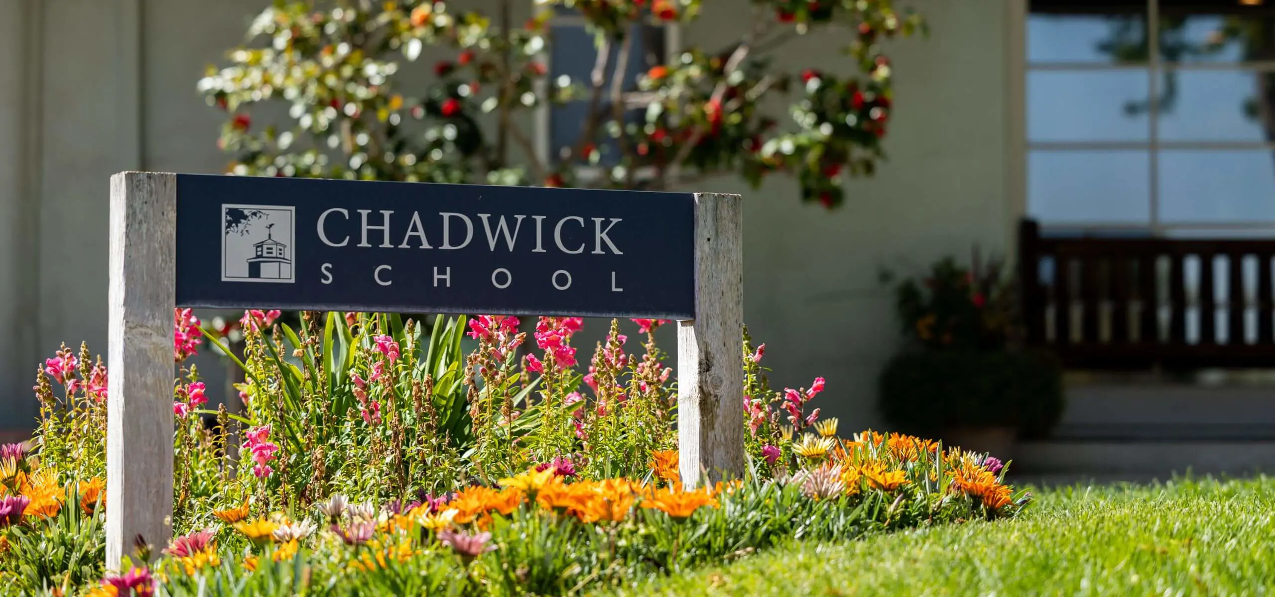 Chadwick School sign with lawn and flowers in bloom.