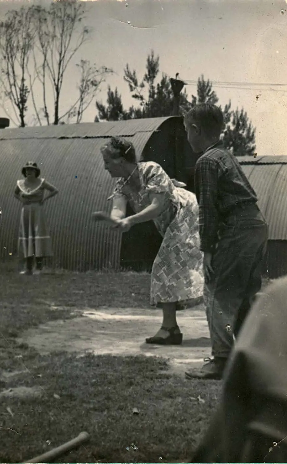 Founder Margaret Chadwick swings a bat in a game of baseball on campus.