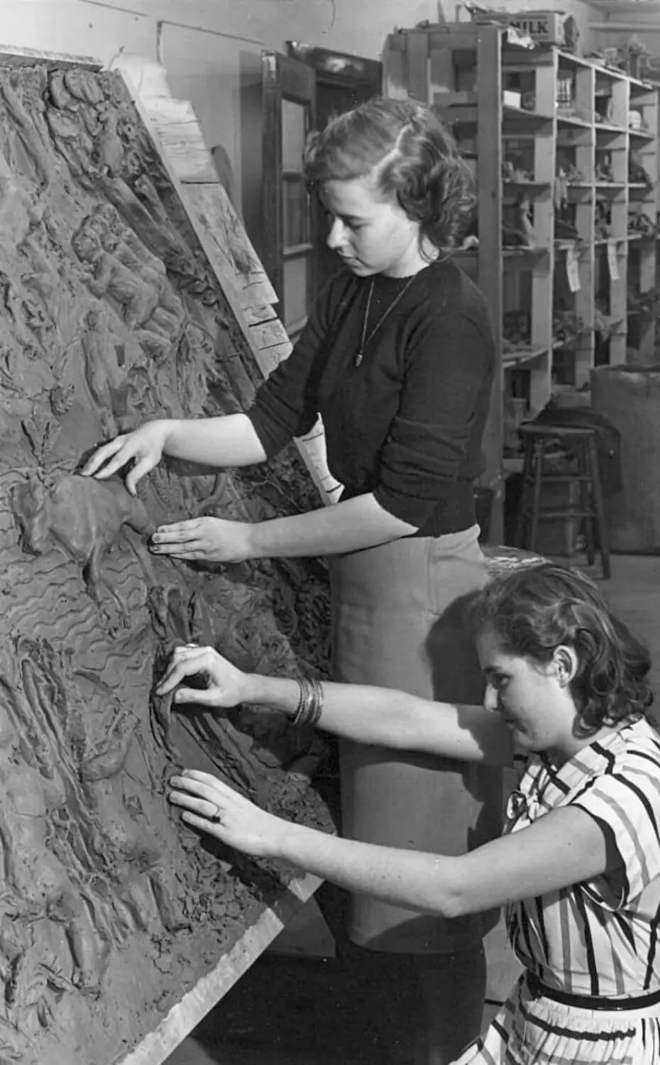 Two Chadwick students work on the clay Hamner mural. 