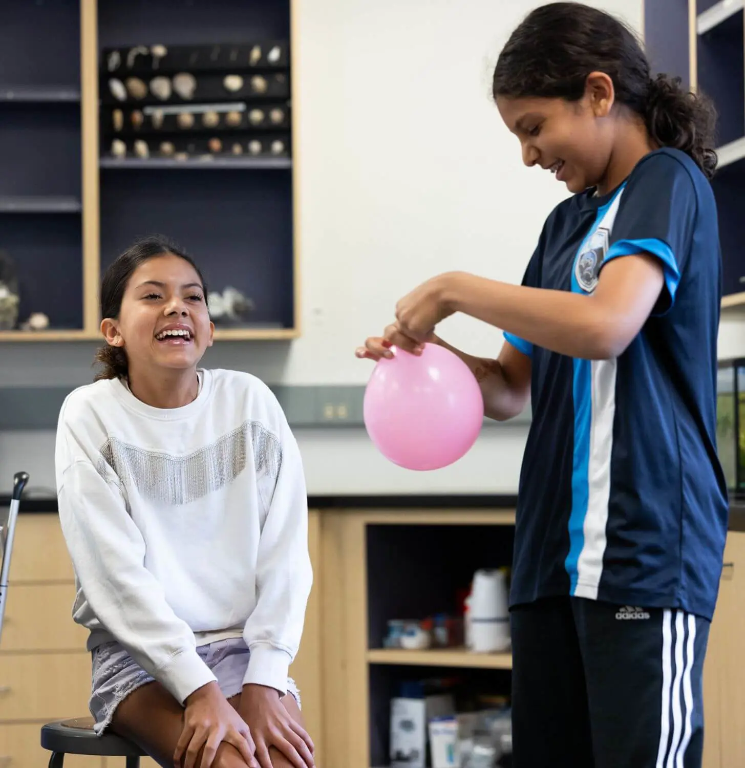 Two students share a laugh during a lab in science class.