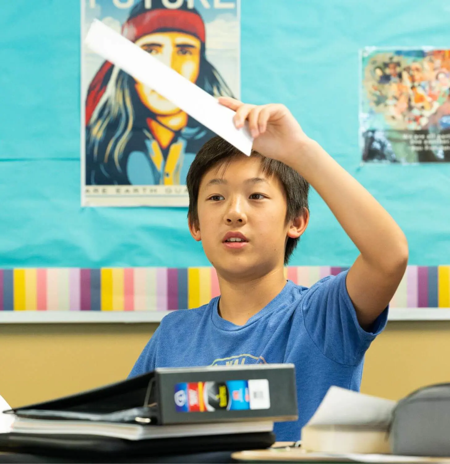Middle School student raises their hand in English class.