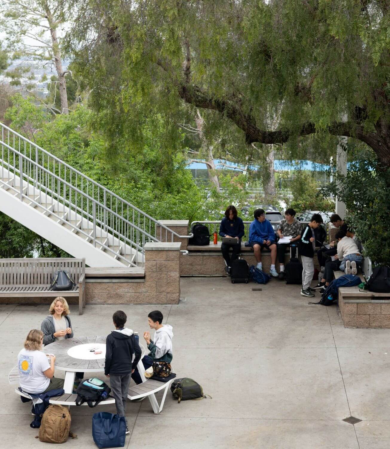 Middle School students sit at tables in the MacFarlane Family Courtyard.