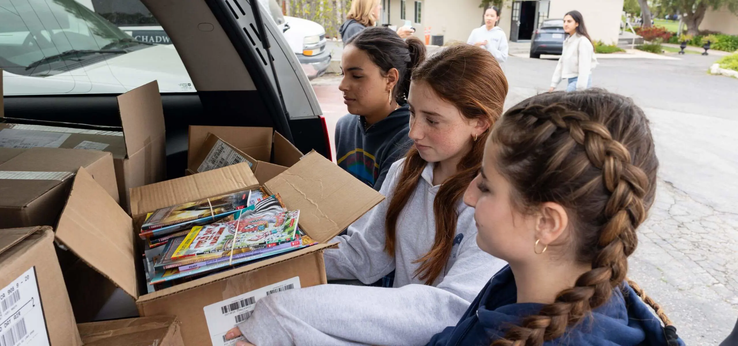 The Middle School Community Service board gathers books to donate to an Elementary School in need.