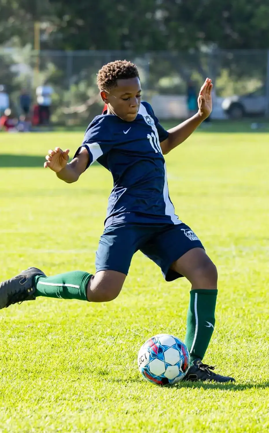 Middle School student takes a shot at the goal during a soccer game.
