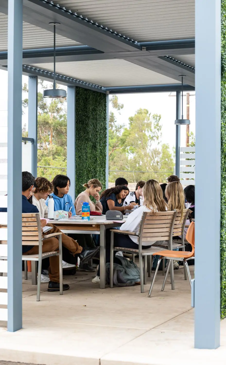 Upper School English class meets outside in the Outdoor Living and Learning Center.
