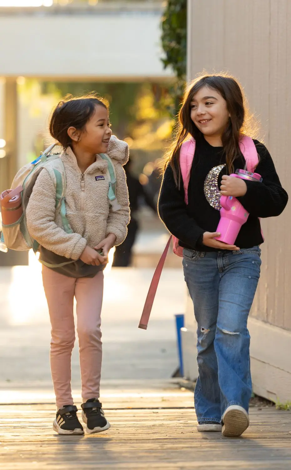 Two Village students walk to class.