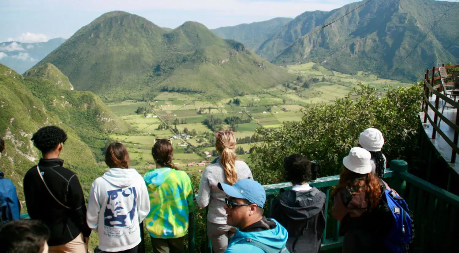 Upper School students hiking in the Mountains in Nepal, viewing the valley below.