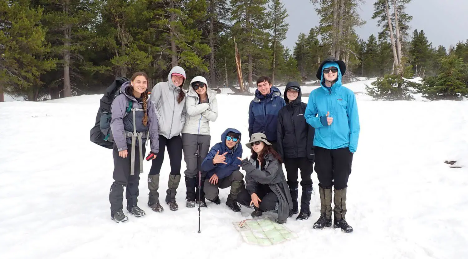 Upper School students hiking through the snow on an outdoor education trip.