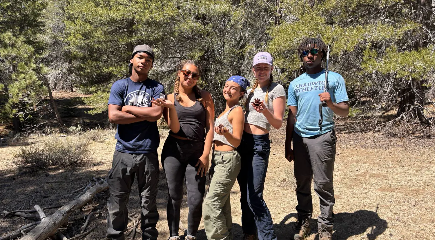 Upper School students posing for a photograph together on an outdoor education trip.