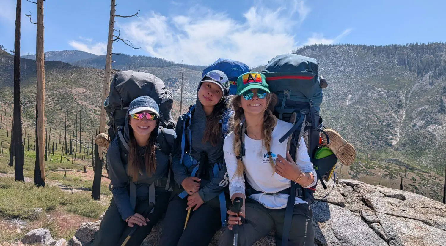 Upper School students hiking through the mountains on an outdoor education trip.
