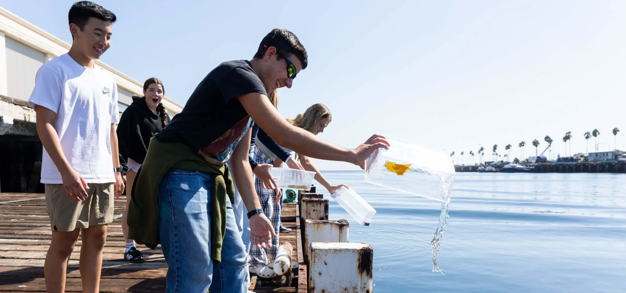 Students dump water samples back into the ocean in San Pedro while at AltaSea.