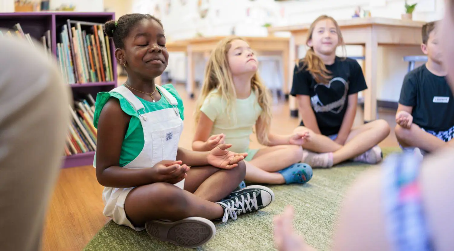 Village students take a mindful meditative moment during class.