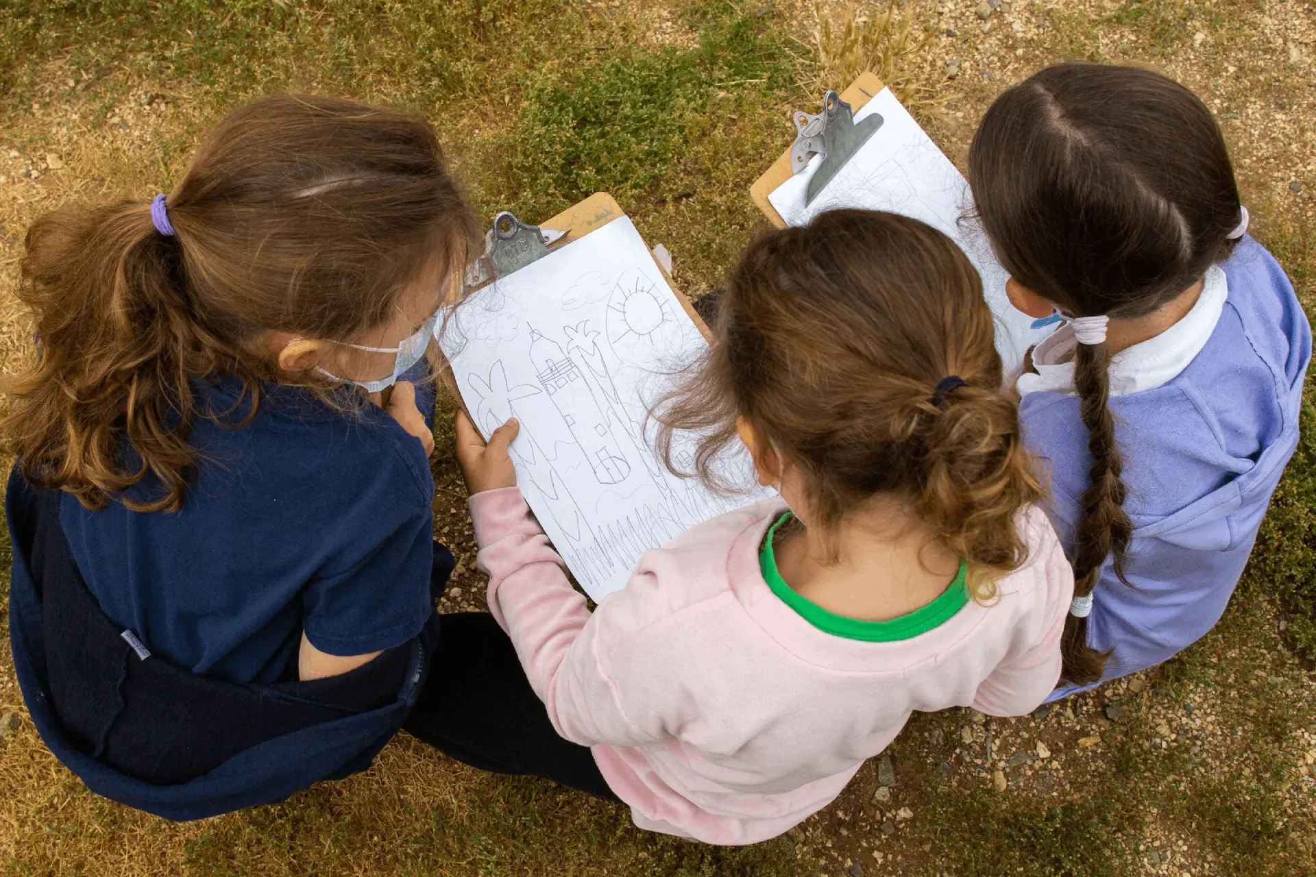 Young students drawing in notepads